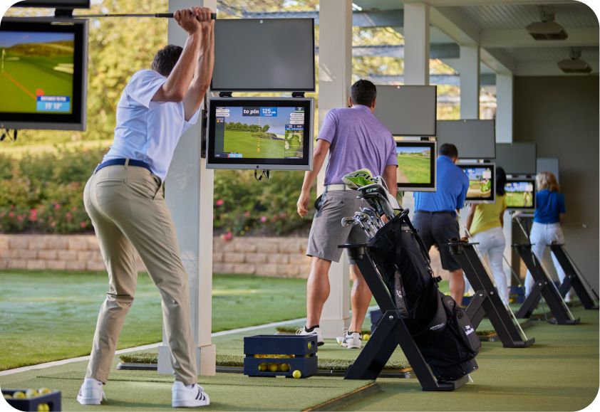 Golfers at a Toptracer bay